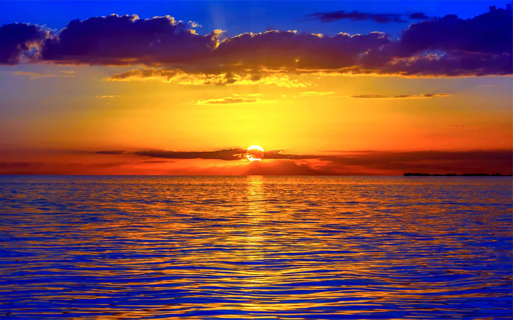 Wallpaper Sunset over the ocean 2560x1080