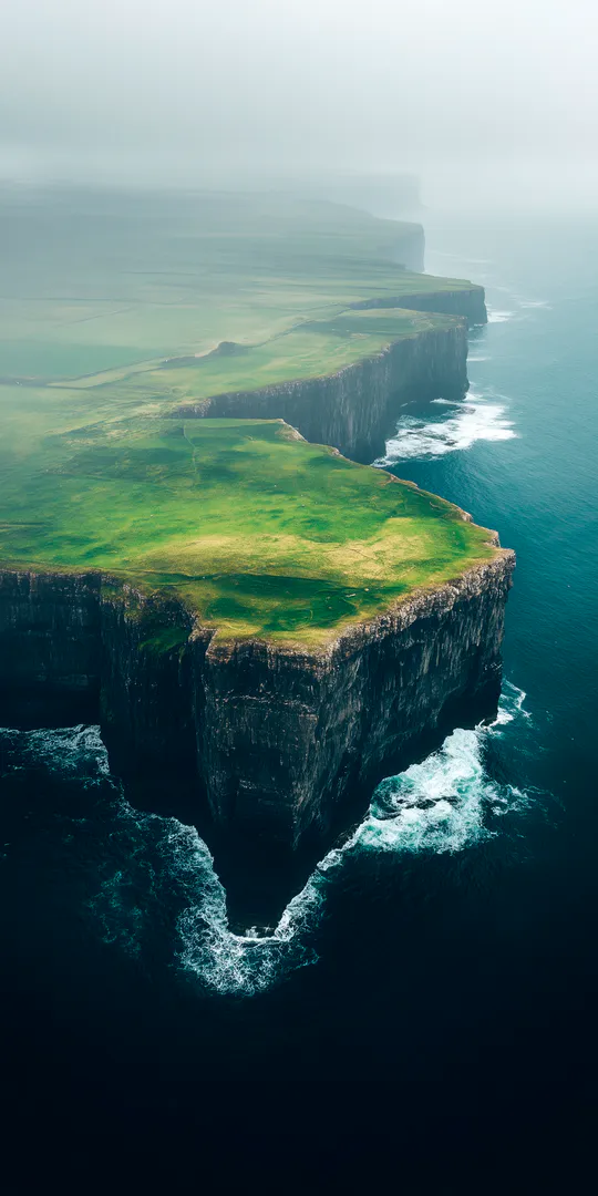 Phone wallpaper: Foggy sea cliffs